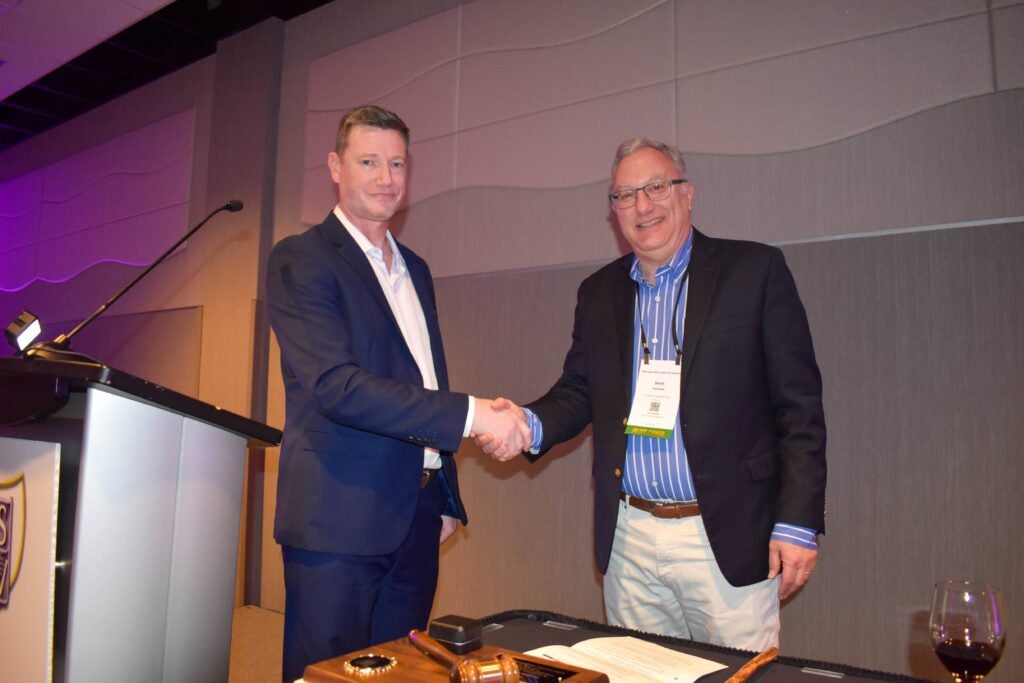 Dr. James Osborne shaking hands with Dr. David Block, 2026 Merit Award recipient